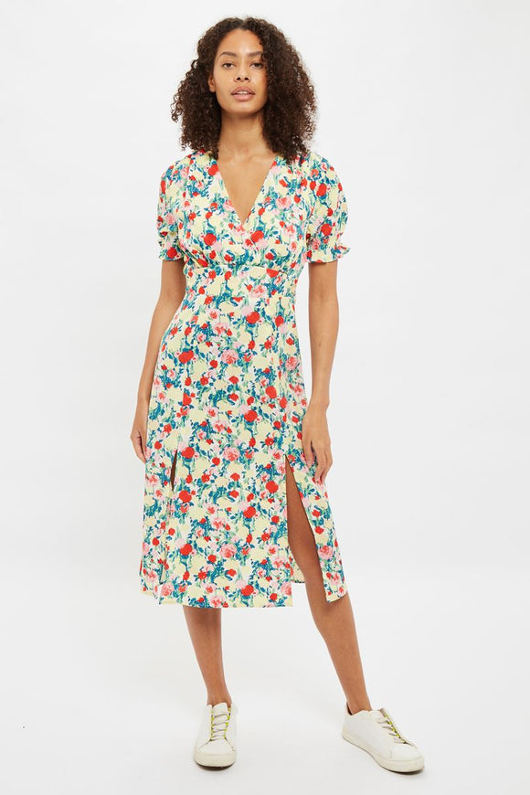 Brighten up your life with this Louche London CORINA Monet Flower Print Midi Dress. The cheery, bright retro floral print is sure to please. Featuring a wrap bodice, short smocked cuff sleeves and a back elasticated waist for definition and comfort, creating an oh so flattering silhouette. This dress, like the sun will take your right through spring and summer and definitely brighten your day.