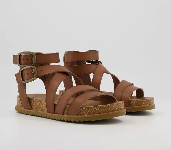 Blowfish Malibu FANDIE Ladies Tan Strappy Sandals. Step out n style in these Blowfish Malibu FANDIE Ladies Tan Strappy Sandals.  Sandals by Blowfish  The FANDIE sandal features a moulded footbed and multiple asymmetrical strap upper. The adjustable buckles make putting these on a total breeze.