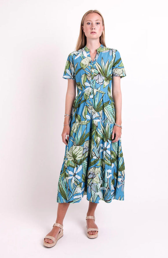 Pretty Vacant MAXI Ladies Blue Floral Print Tiered Dress. A half- button front, loose fitting tiered dress in an eye-catching blue floral print. Step into the new season in this Pretty Vacant MAXI Ladies Blue Floral Print Tiered Dress. A throw-on and go garment that looks great with summer sandals.