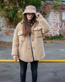 A cosy cross between a shirt and a jacket, wear this Lottie&Moll VEDA Ladies Beige Fake Fur Shacket to keep you warm on the coldest of days. With a button front, two big flap front pockets and a curved hemline, shop the shacket look in this furry cotton and wool mix outer layer. A warm winter must-have!